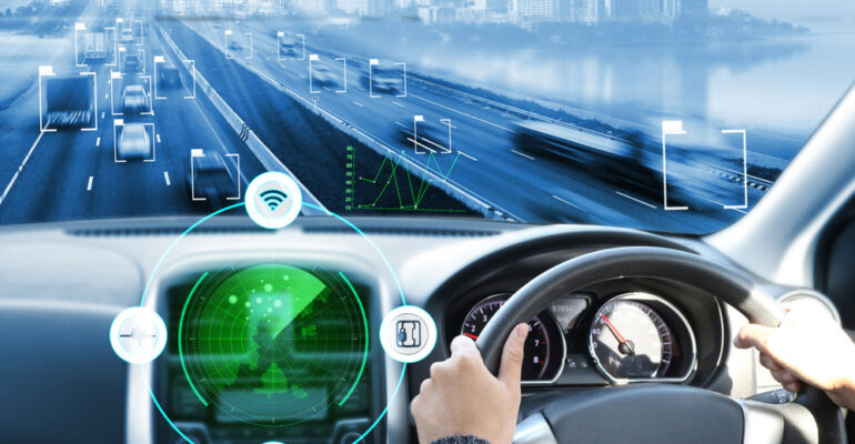 Futuristic car being driven on the road with the steering wheel visible