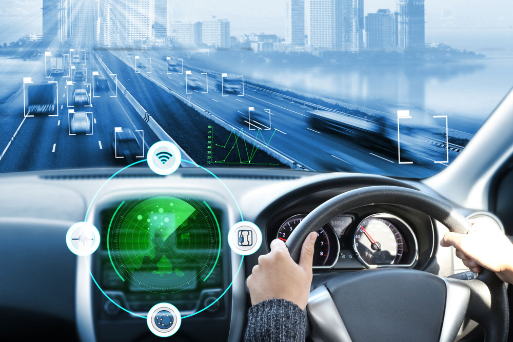 Futuristic car being driven on the road with the steering wheel visible