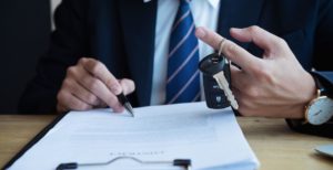 Signing a business car lease while holding car keys