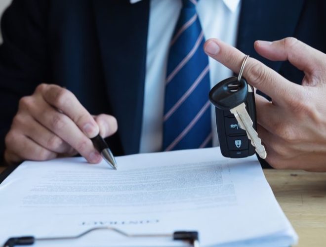 Signing a business car lease while holding car keys