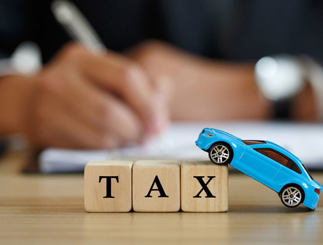 building block letters saying tax and toy blue car