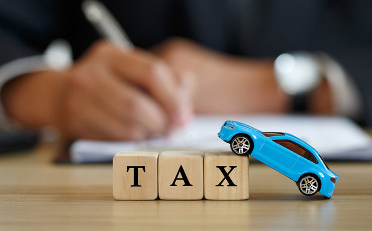 building block letters saying tax and toy blue car