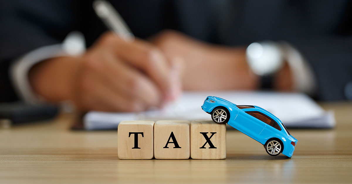 building block letters saying tax and toy blue car